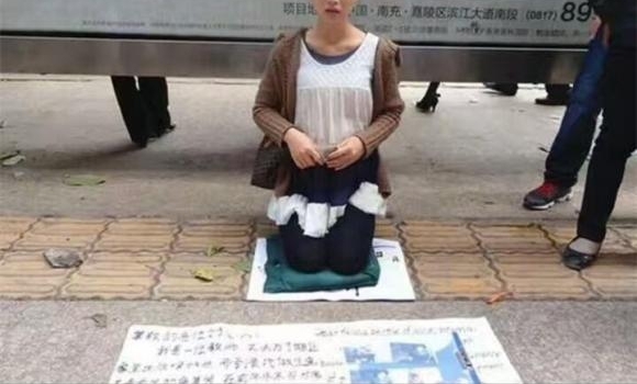 美女塞毛毯扮“孕妇”跪街乞讨 网友发图揭穿骗局